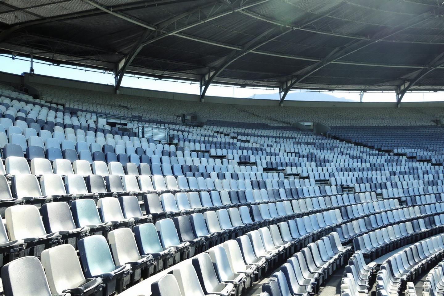 Rangées de sièges bleus et blancs dans un stade désert